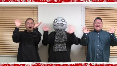 NieR series producer Keiichi Okabe, music producer Yosuke Saito, and creative director Yoko Taro waving at the screen