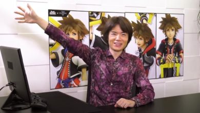 Masahiro Sakurai sitting at a desk in front of a wall with different pictures of Sora