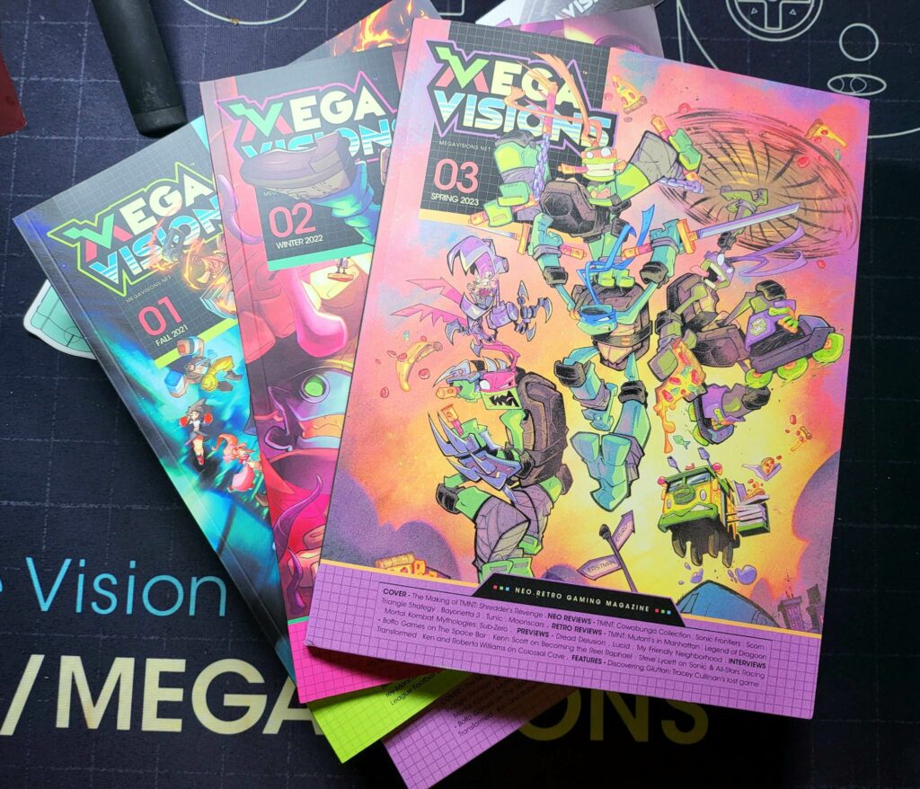 Cover of Mega Visions Issue #03 laying on top of previous issues.